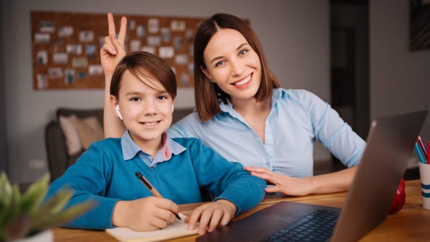A Preteen boy uses a laptop to make a video call with his teacher. The Screen shows an online lecture with a teacher explaining the subject from class.