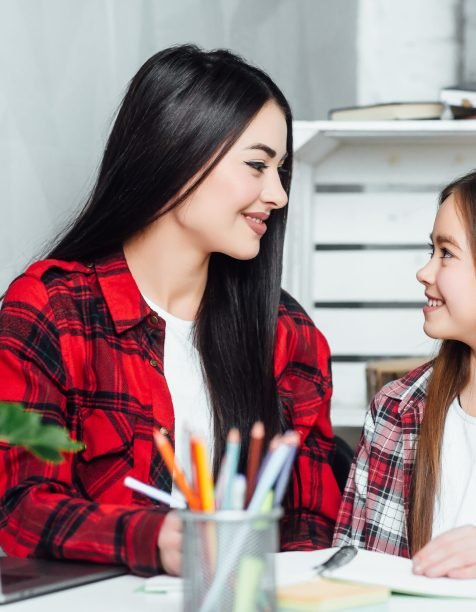 Sister, what are you doing? Two little girls working homework at home.